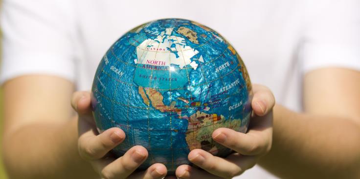 Hands holding globe
